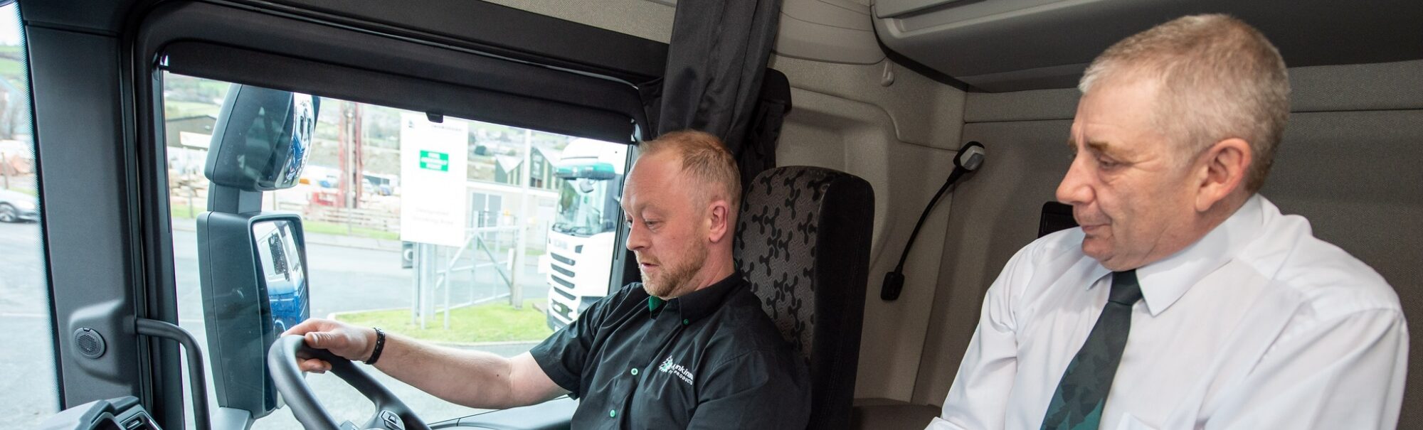 A driver is in the driver seat with Kevin Wood accompanying with a clipboard