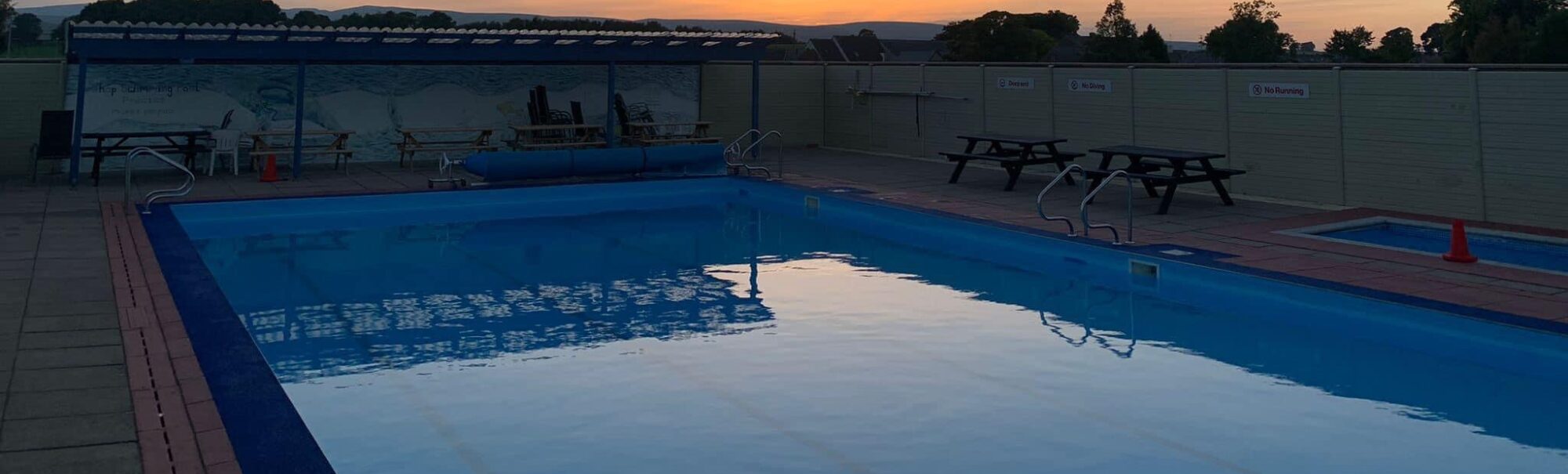 Pool with sunset in the background
